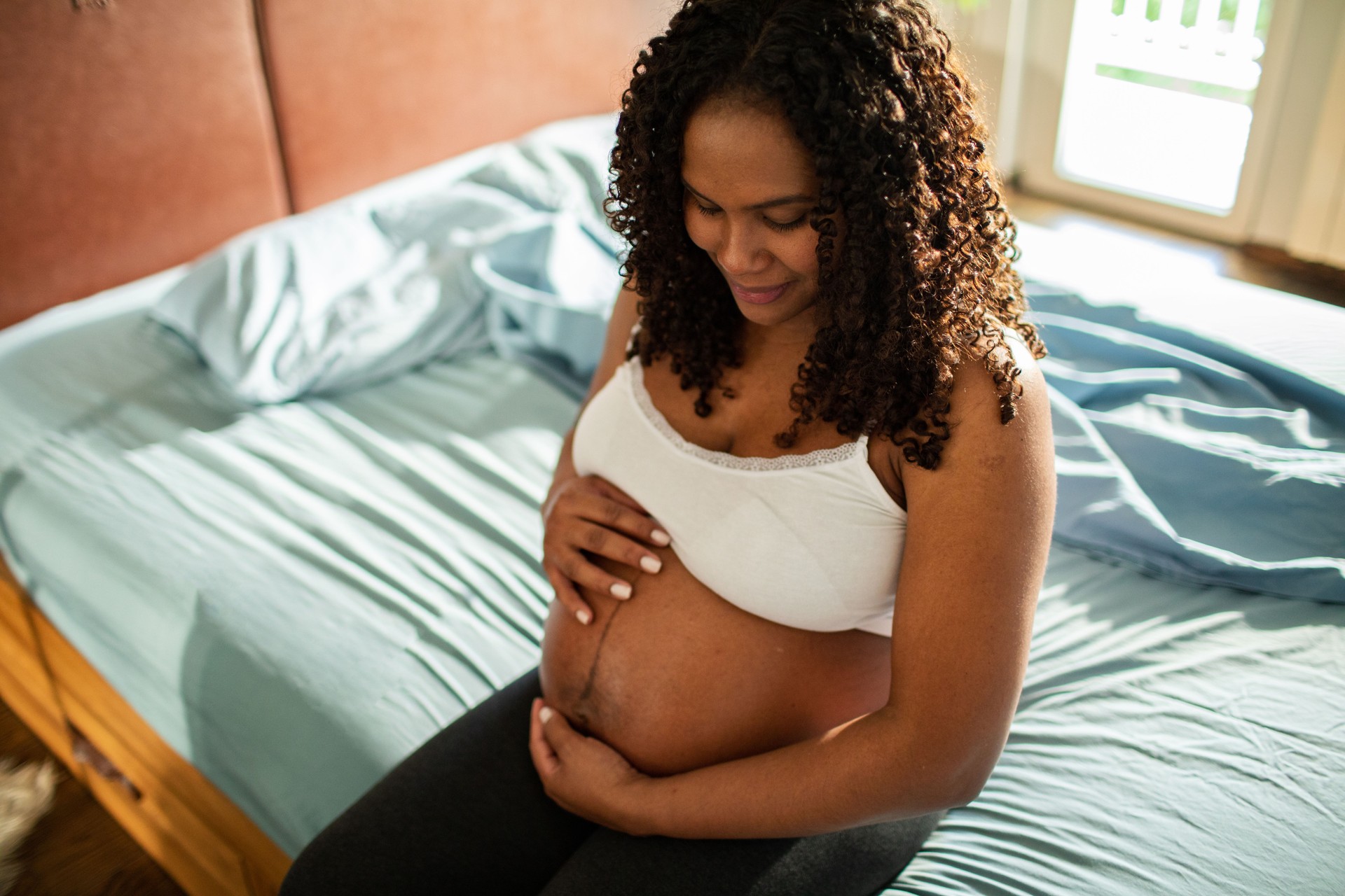 Pregnant woman waking up in the morning