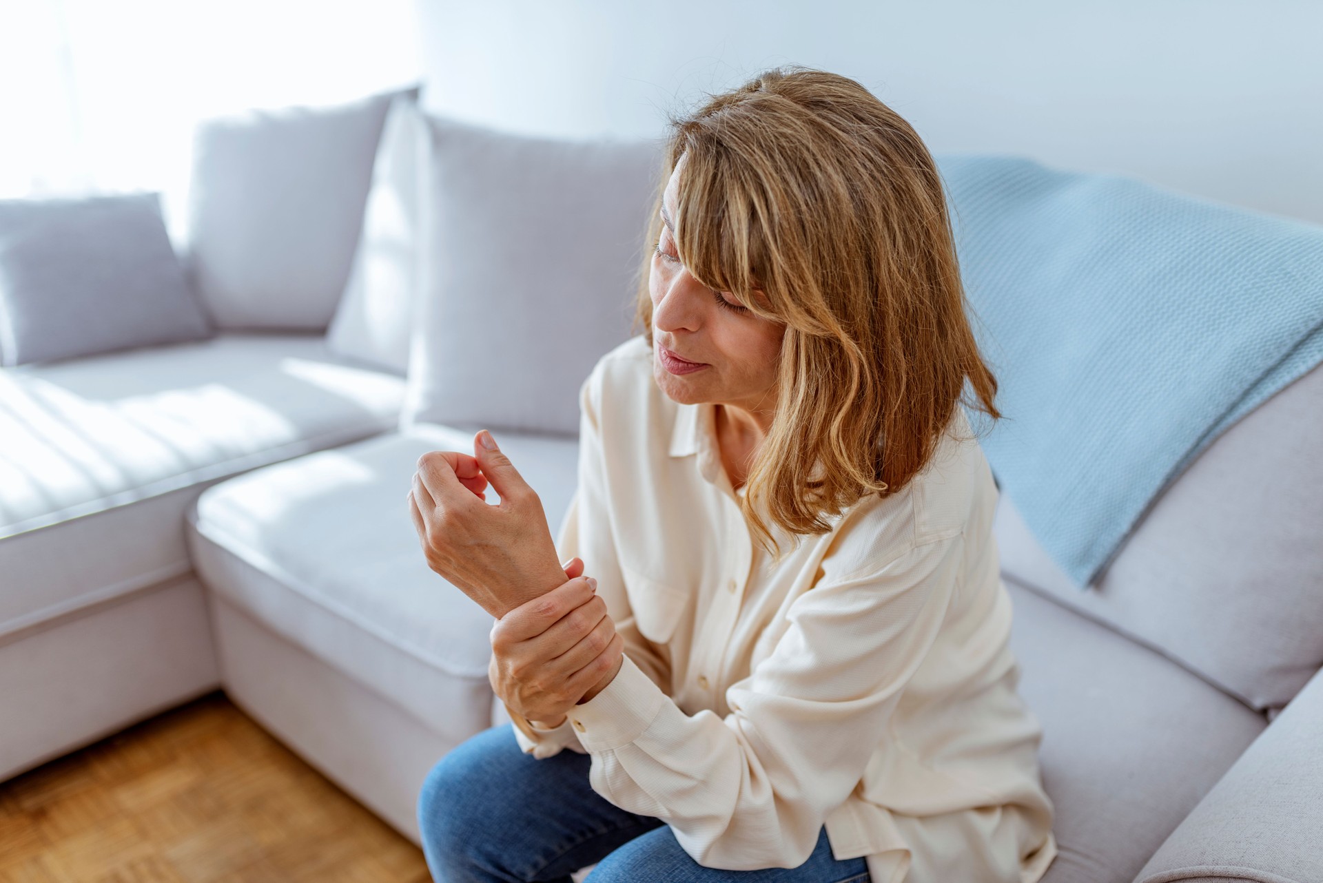 Woman holding painful wrist