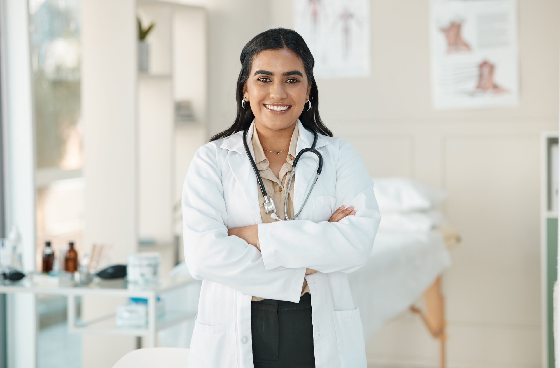 Shot of an attractive young doctor standing alone in her clinic with her arms folded