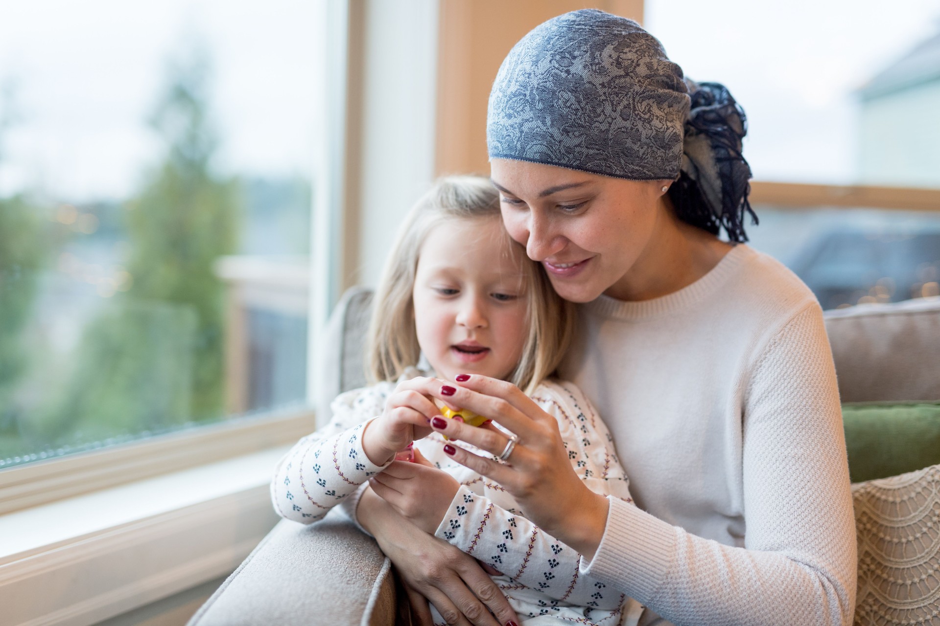 Young mom with cancer holds her daughter